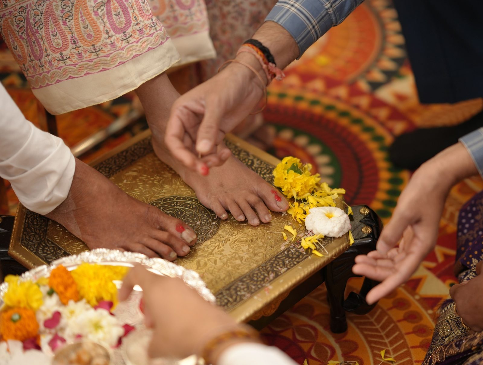 A ritual moment with marigolds on a brass stool