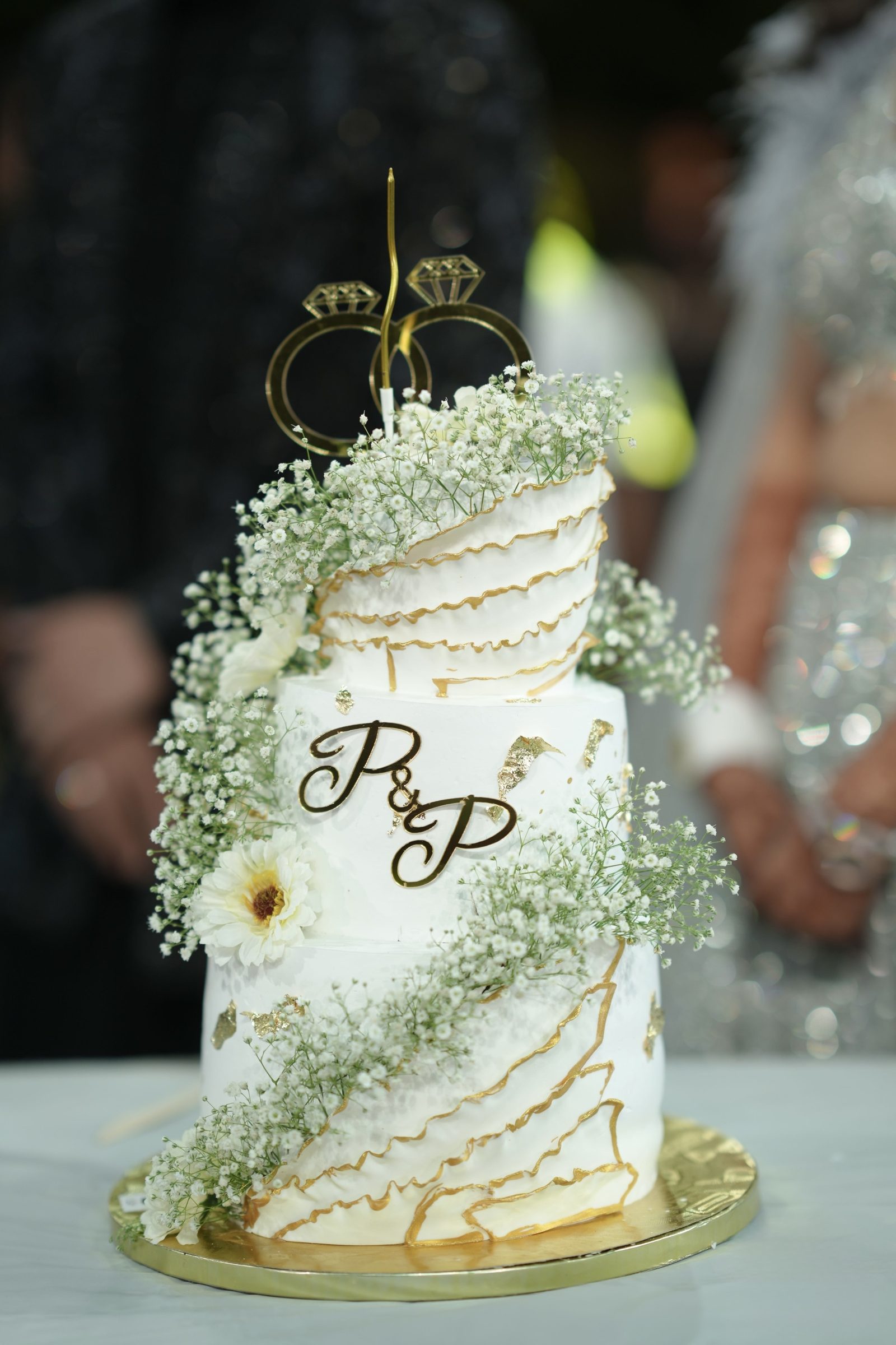 Wedding cake detailed with gold and fresh blooms