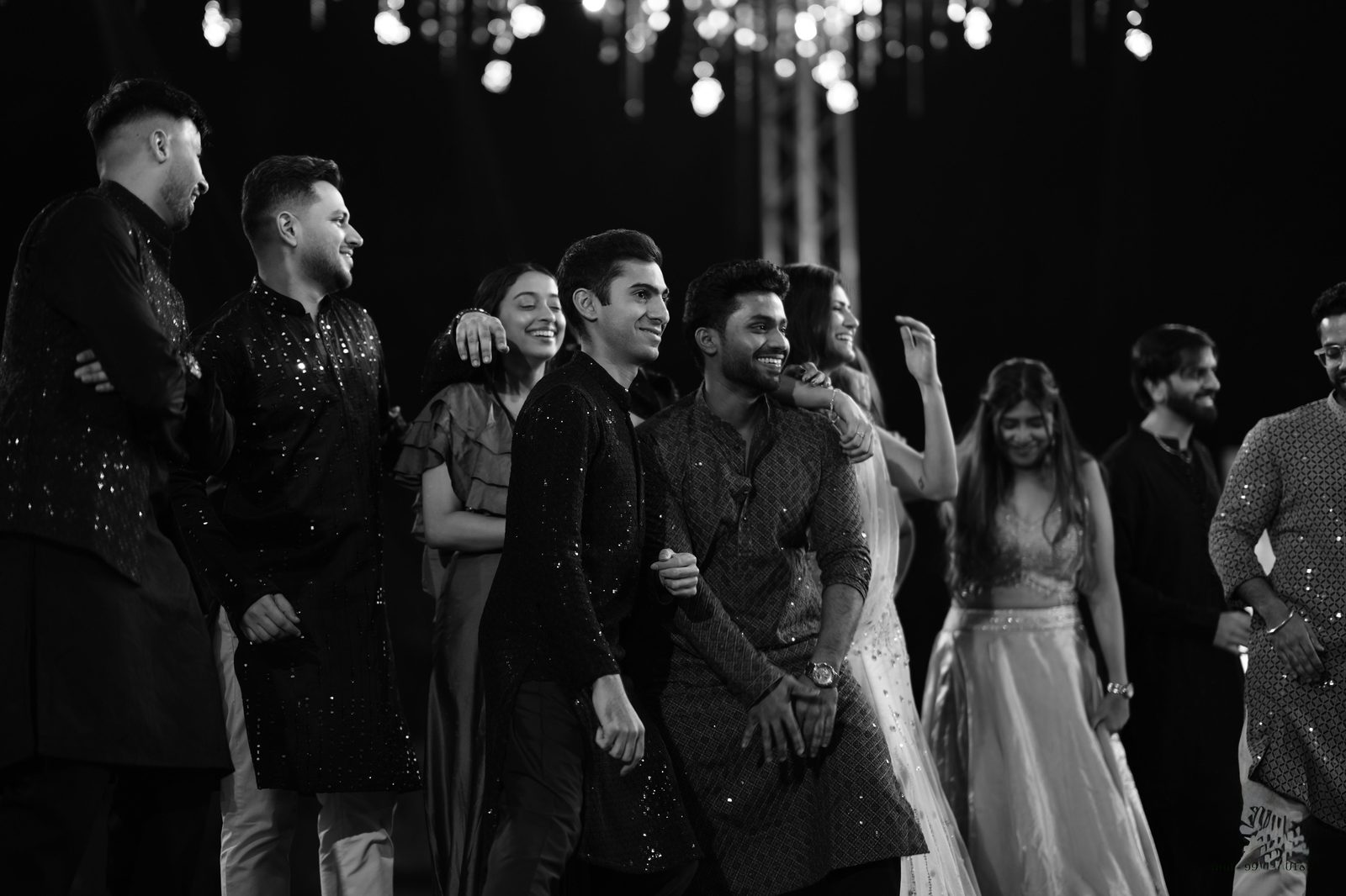 Friends together at a sangeet, in black and white