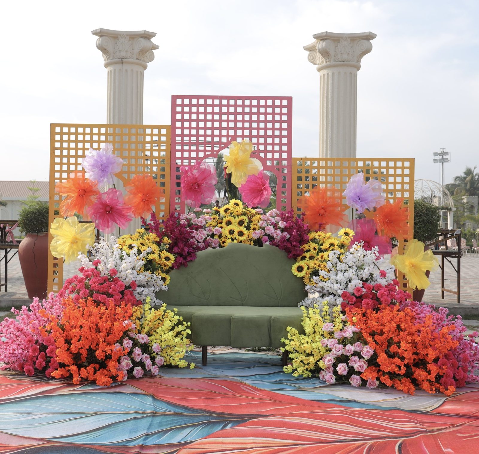 Vibrant stage of oversized blooms and lattice screens