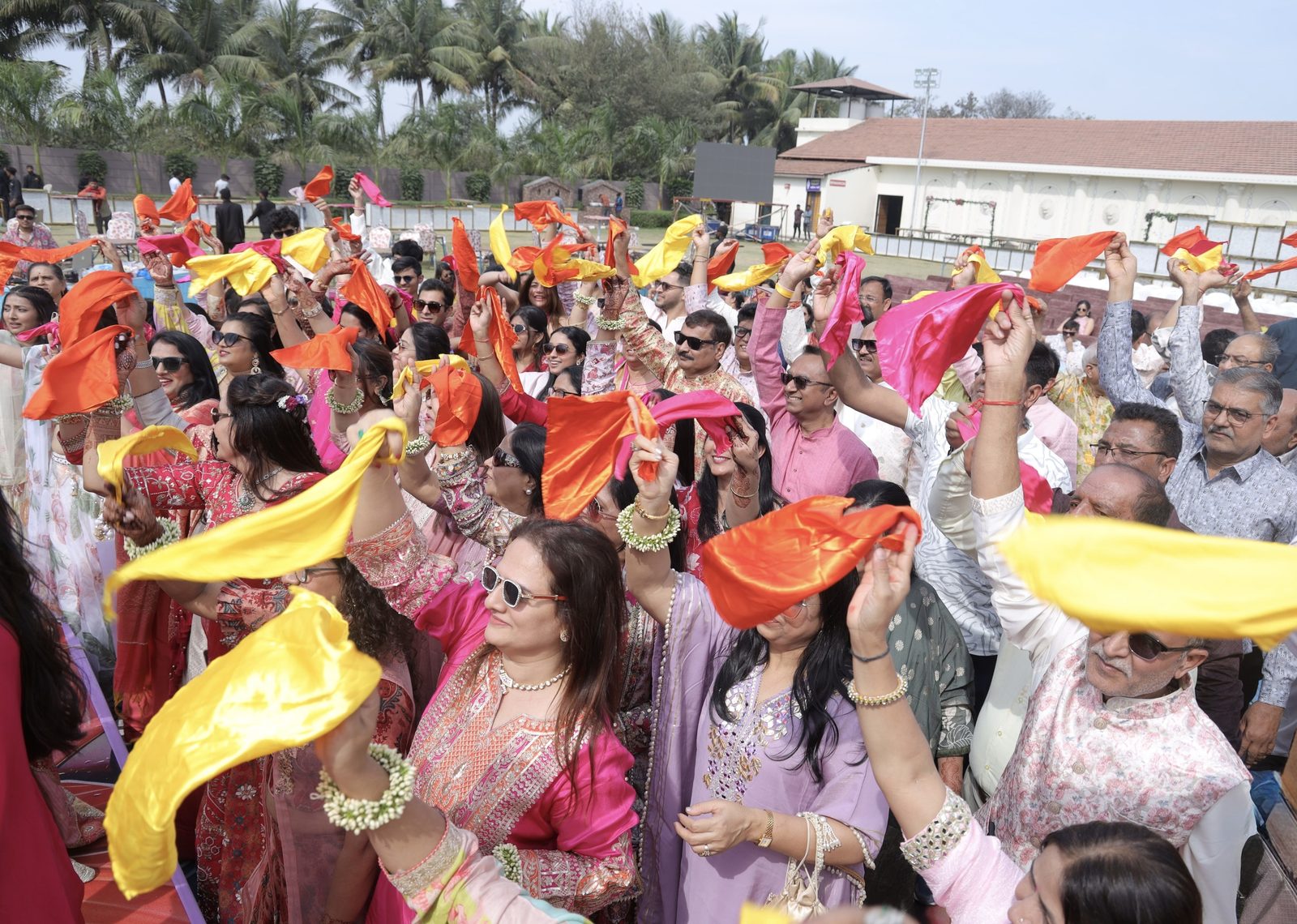 Guests waving marigold handkerchiefs
