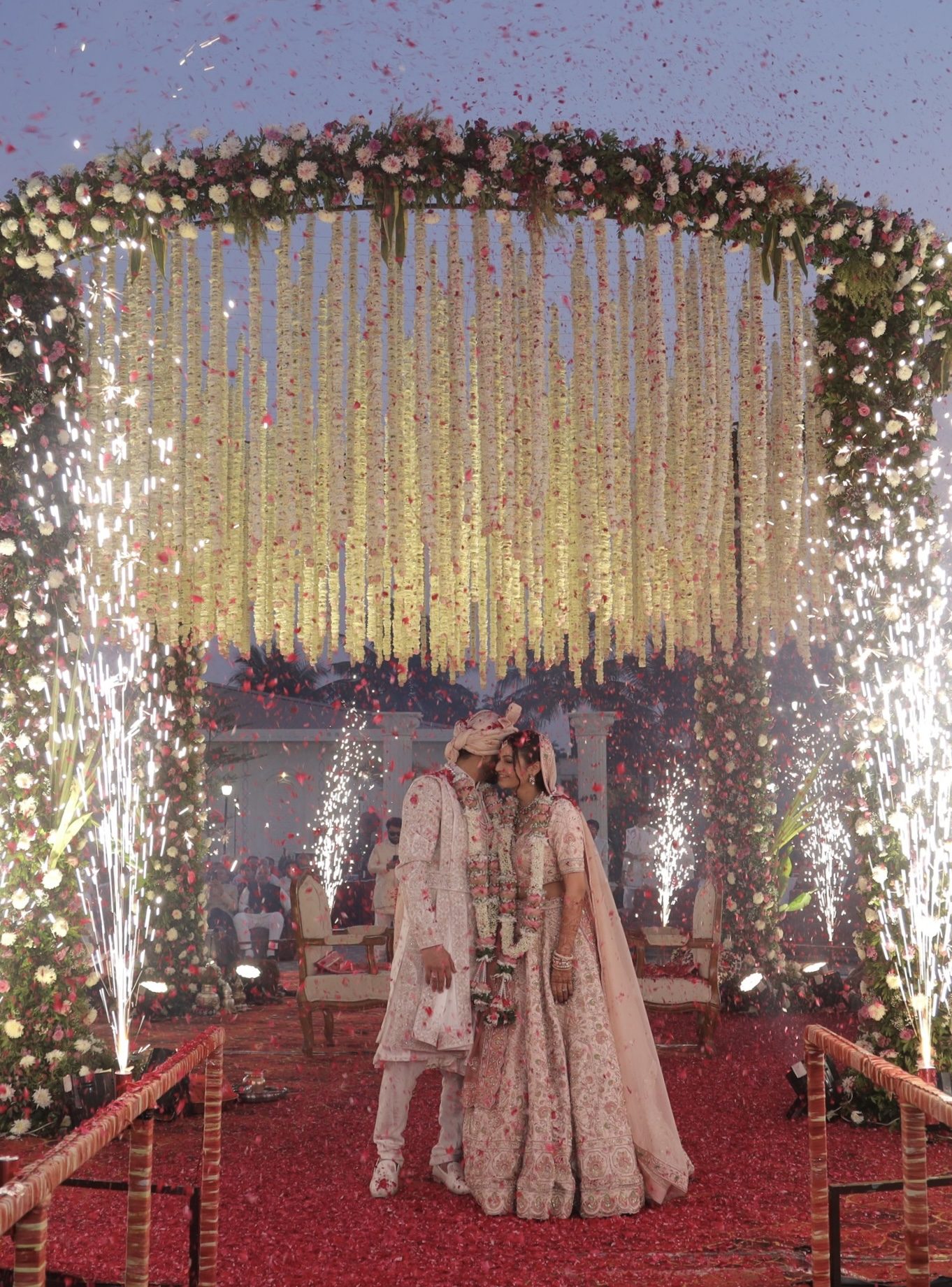 Outdoor mandap crowned with hanging garlands
